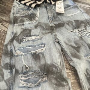 shiny jeans with holes, flared at the bottom